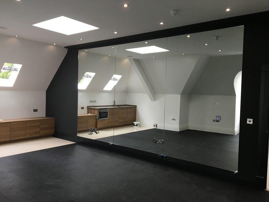 Frameless glass wall dividing loft conversion in Aylesbury